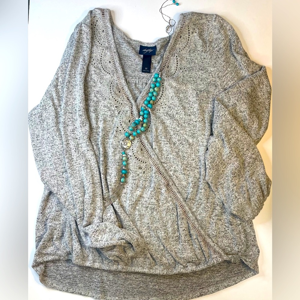 Grey sweater, eyelet details, soft knit.